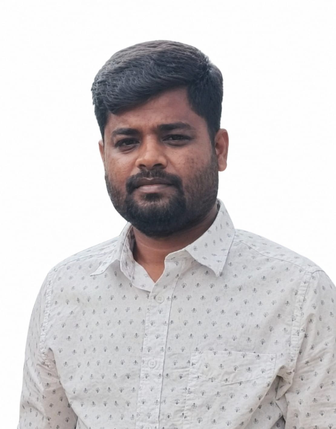 Mr M Dhineshkumar smiling with confident friendly energy in a softly lit office environment